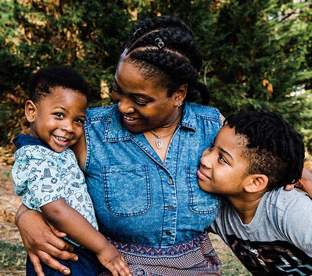 Mother embracing children Mother embracing children
